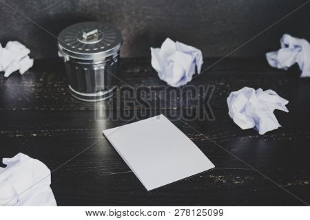 Garbage Bin On Desk Setting With Empty Notepad And Scrunched Paper Balls, Concept Of Drafting And St