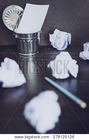 Garbage Bin On Desk Setting With Empty Notepad And Scrunched Paper Balls, Concept Of Drafting And St