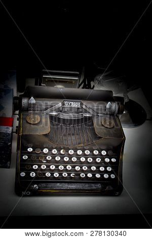 Retro Syled Tiny Typewriter Model On A White Background