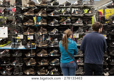 Bucharest, Romania - January 12, 2019: Customers In Front Of Winter Sneakers Shelf In The French Spo