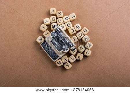 Letter Cubes Of Made Of Wood Around Model Typewritter