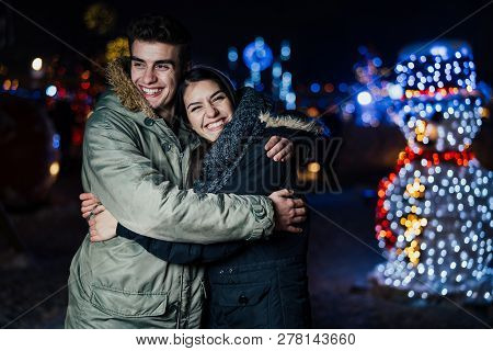 Night Portrait Of A Happy Couple  Smiling Enjoying Winter And Snow Aoutdoors.winter Joy.positive Emo