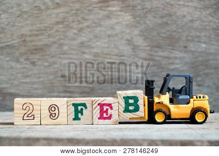 Toy Forklift Hold Block B To Complete Word 29feb On Wood Background (concept For Calendar Date 29 In