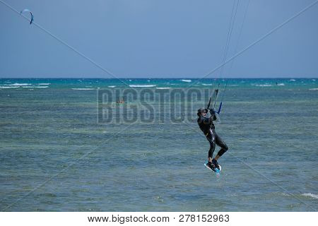Mui Ne, Vietnam - 11 2018: Kitesurfing, Kiteboarding, Kite Surf. Extreme Sport Kitesurfing In Tropic