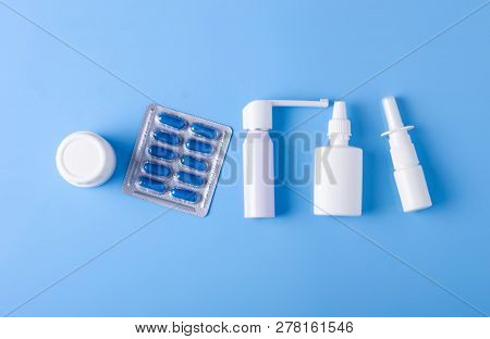 Blue Pills Capsules Nose Throat Spray Medicine Health On Blue Background Top View, Medical Pharmacy 