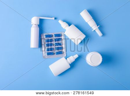 Blue Pills Capsules Nose Throat Spray Medicine Health On Blue Background Top View, Medical Pharmacy 