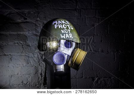 Art Picture Of A Military Gas Mask On A White Brick Wall With Shadows With Flash With The Inscriptio