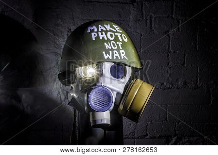 Art Picture Of A Military Gas Mask On A White Brick Wall With Shadows With Flash With The Inscriptio