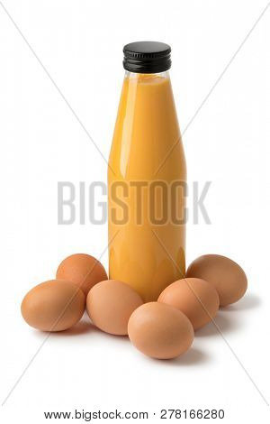 Bottle traditional dutch egg liqueur, called advokaat, and fresh eggs isolated on white background