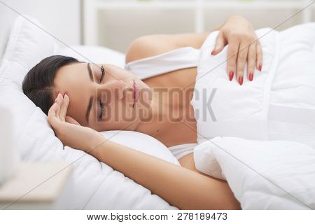 Cold And Flu. Woman Sleep And Hold Her Head With Subliminal Stress Or Other Possible Symptoms