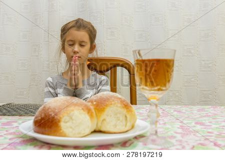 Child Prays At Shabbat. Little Jewish Sabbath. Jewish Child At The Sabbath Table.