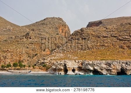 View From The Sea On Marmara Beach And Entrance To Aradena Gorge, South-west Coast Of Crete Island, 