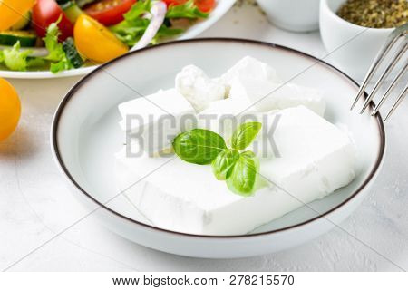 Fresh Greek Feta Cheese In A Bowl Whole And Slices For Salad With Vegetables