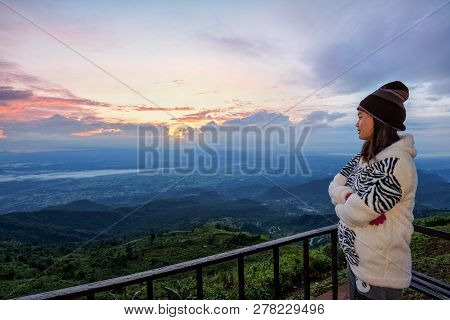 Woman Tourist In A Sweater Dress Standing Watching The Beautiful Nature Landscape Of The Forest And 