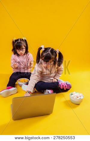 Curious Small Girls With Genetic Disorder Spending Time With Laptop