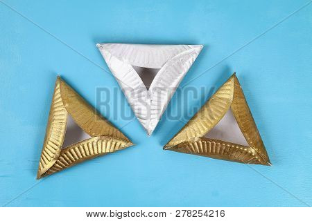 Purim. Diy Cookies Hamantaschen Of Cardboard Plates With Sweet Surprise Inside On Blue Background. G