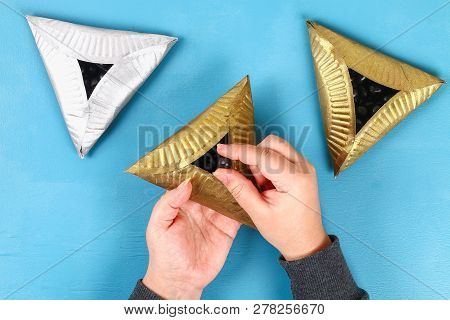 Purim. Diy Cookies Hamantaschen Of Cardboard Plates With Sweet Surprise Inside On Blue Background. G