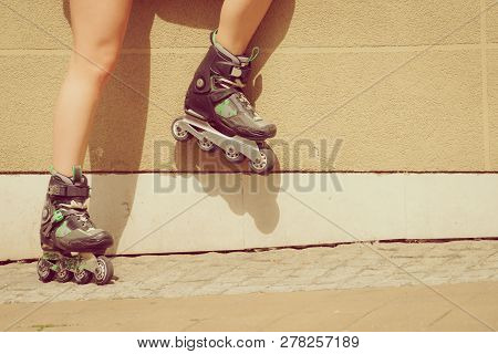 Woman Wearing Roller Skates In Town. Female Being Sporty During Summer Time.