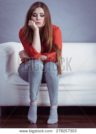 Angry, Pissed Off Young Woman. Attractive Female With Long Brown Hair Sitting On Sofa Being Mad And 