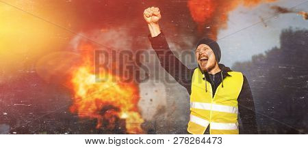 Protests Yellow Vests. The Man Raised His Hand Into A Fist And Shouted. Concept Of Revolution And Pr