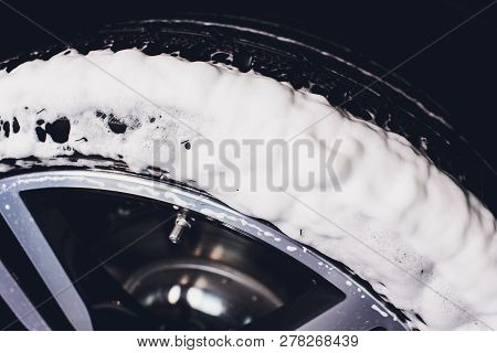 Car Care Or Car Detailing Process. Using Black Sponge To Washing The Tire. Blacker Rubber.