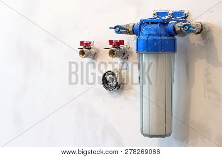 Water Filter New Installed On A Kitchen Wall To Purify Drinking Water.
