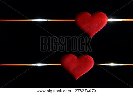 Two Red Hearts Lie On A Black Background And Glowing Lines. The Life Path Of A Person, Life And Deat