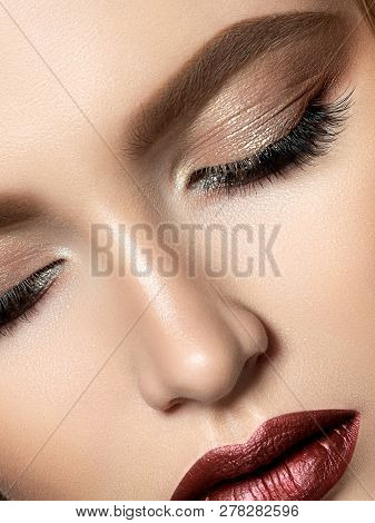 Close Up Beauty Portrait Of Young Woman With Dark Red Lips And Brown Smokey Eyes Makeup. Perfect Ski
