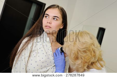 Doctor Examining Birthmarks And Moles Patient. Examination Of Birthmarks And Moles.the Doctor Examin