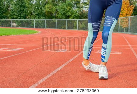 Woman Legs Stumbling On The Run Track During Running