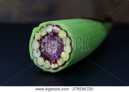 Fresh Purple Corn Fruit Cut Haff On Table