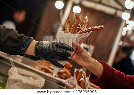 Close-up Of Young Blonde Woman Buying Churros
