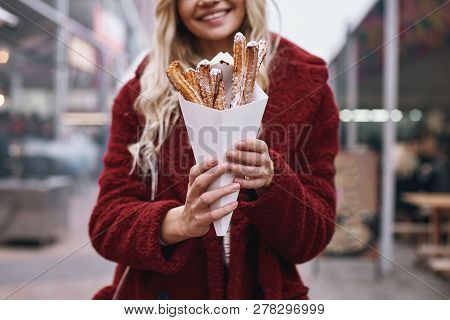 Close-up Of Young Blonde Woman Eatting Churros