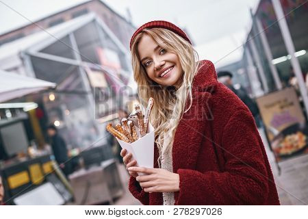 Close-up Of Young Blonde Woman Eatting Churros