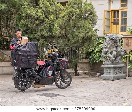 Xiamen, China - 31 October 2018: Sf Courier Bike Delivering Parcels In Central Xiamen