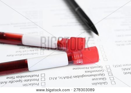 Test Tubes With Blood Samples For Analysis On Laboratory Test Form, Closeup