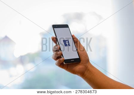 Chiang Mai, Thailand - Oct. 28,2018: Man Holding Huawei With Facebook App On The Screen. Facebook Is