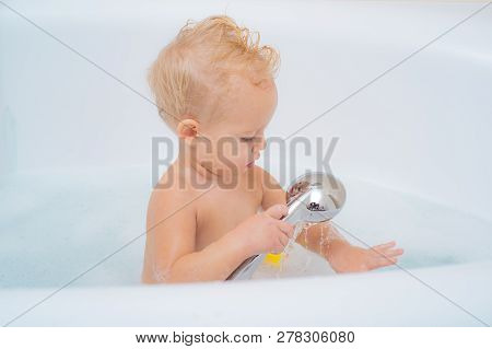 Wash Infant Hygiene And Health And Skin Care. Funny Cheerful Toddler Cleaning Body In The Bath. Baby