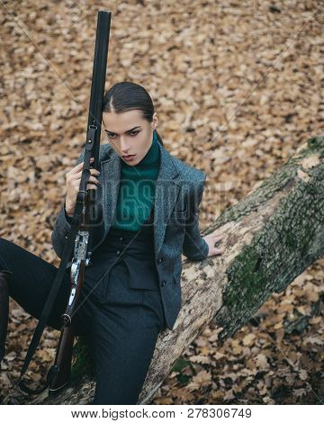 Female With A Gun. Hunter Woman. Hunter With A Backpack And A Hunting Gun. A Hunter With A Hunting G