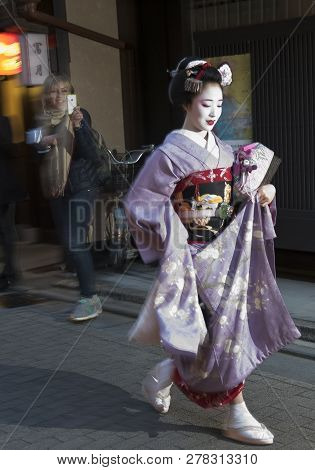 Kyoto, Japan - April 10: Tourist Chasing Geisha In Kyoto, Japan On April 10, 2016. Geisha In Western