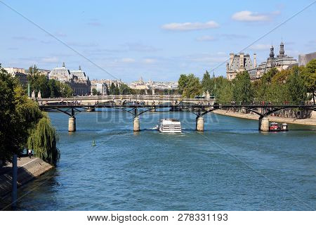 White Boat Crosses The Seine In Paris Passing Under A Bridge