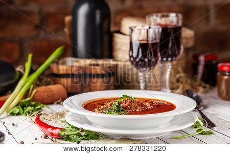 Traditional Georgian And Armenian Cuisine. Tomato Soup With Rice Harcho Of Lamb, With Walnut, Garlic