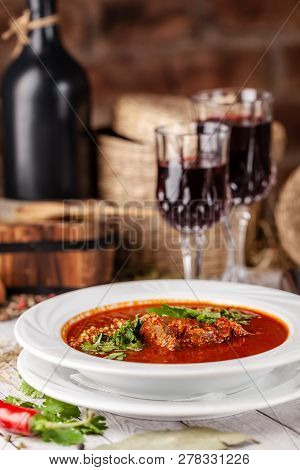 Traditional Georgian And Armenian Cuisine. Tomato Soup With Rice Harcho Of Lamb, With Walnut, Garlic