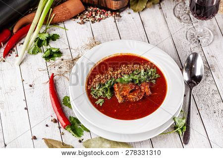 Traditional Georgian And Armenian Cuisine. Tomato Soup With Rice Harcho Of Lamb, With Walnut, Garlic