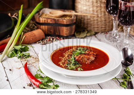 Traditional Georgian And Armenian Cuisine. Tomato Soup With Rice Harcho Of Lamb, With Walnut, Garlic