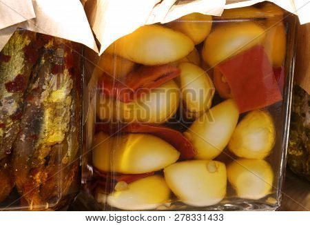 Jar With Garlic Cloves With Red Peppers And Marinated Anchovies In Oil For Sale In The Stall Of The 