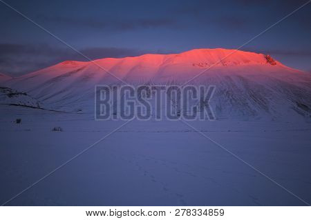 Panoramic View Of Vettore Mountain At Dusk With Snow In The Monti Sibillini National Park