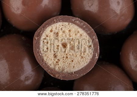 Chocolate Honeycomb Sweets Cut In Half Closeup. High Sugar Food Representing Non Diet Occasional Tre