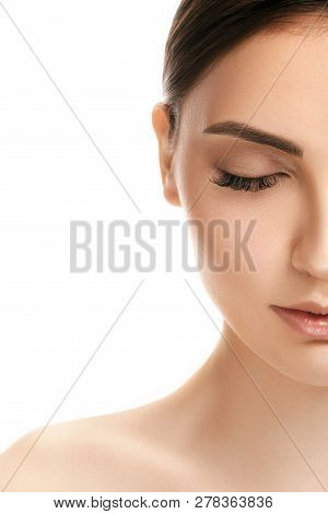 The Beautiful Female Face. The Perfect And Clean Skin Of Face On White. Half Face With Eyes Closed