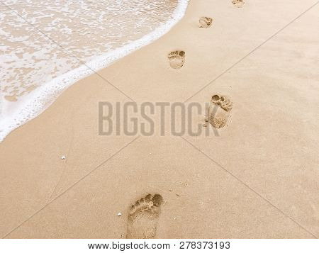 Footprints On Beach Background. Royalty High-quality Stock Photo Image Of Footprint Of Human Feet On